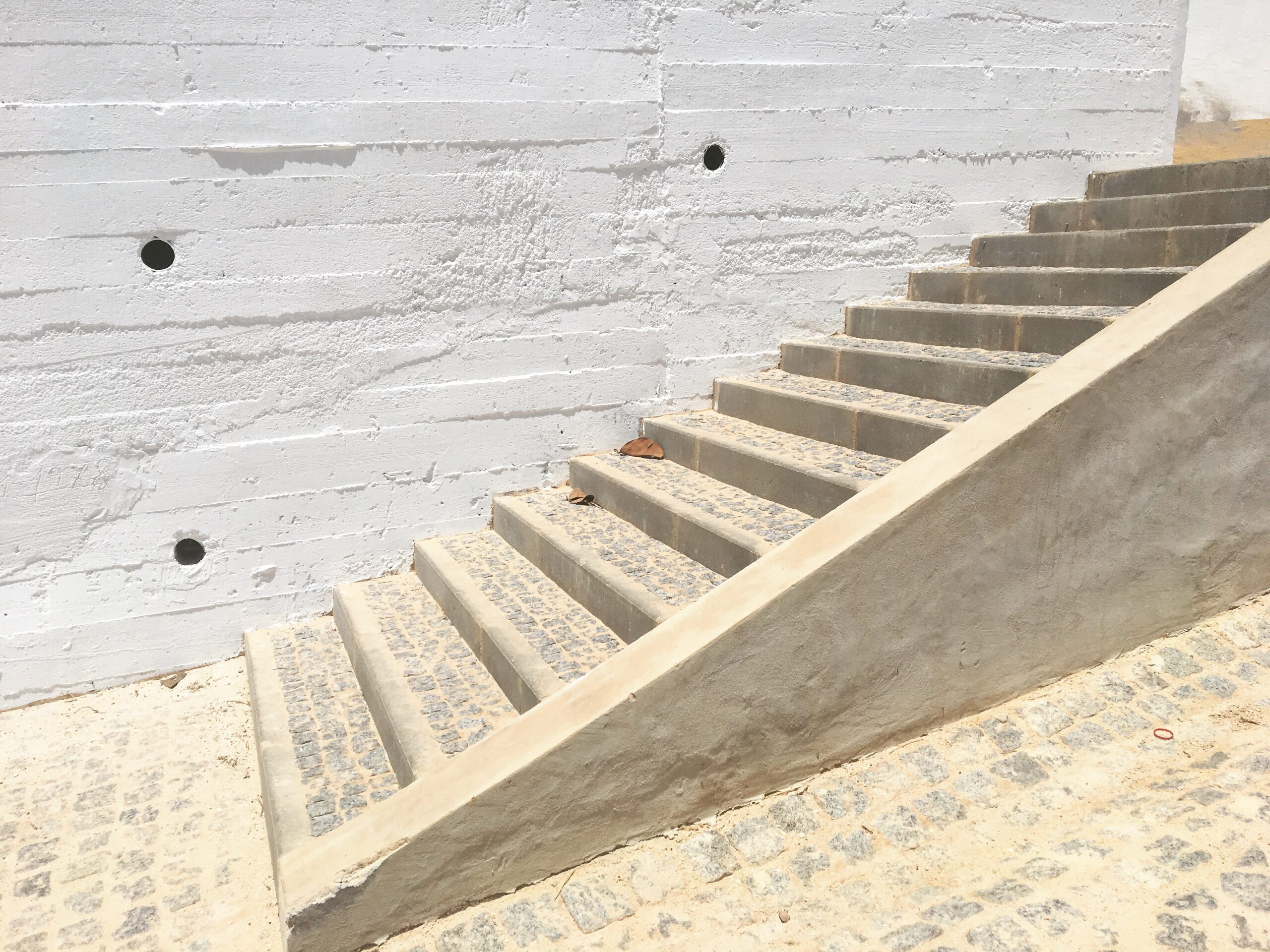 Whitewashed stone steps and textured wall in bright natural light - intentional space design - Rhizo Home